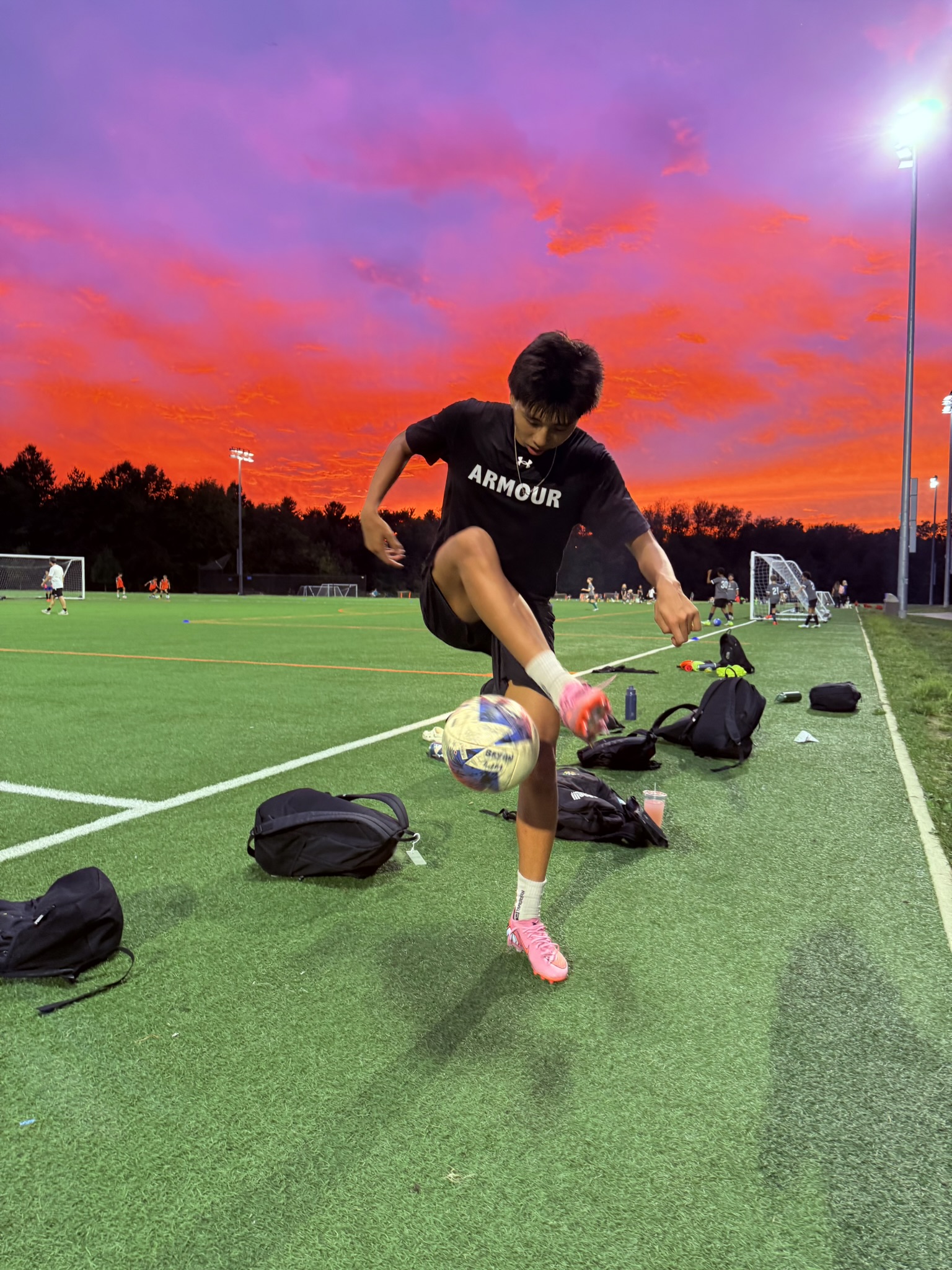Bryan Lim practicing freestyle soccer at sunset
